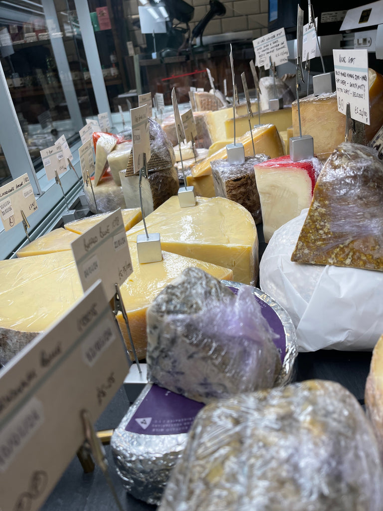 A photo of lots of cheese taken from inside our refrigerated display
